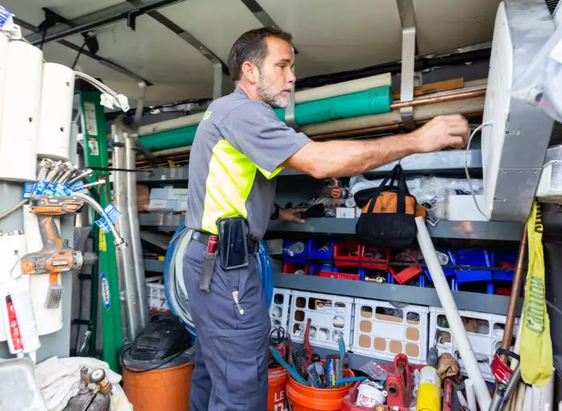 A man in an industrial setting working on some equipment.